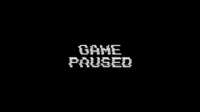game paused glitch text message with a retro effect on black background. ideal for gaming streams, intros, vintage 8-bit game paused text pixel 4k video