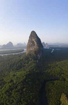 Aerial view, mangrove forest with meandering river and high karst rocks during sunrise, Ao Phang-Nga National Park, Phang-Nga Province, Thailand
