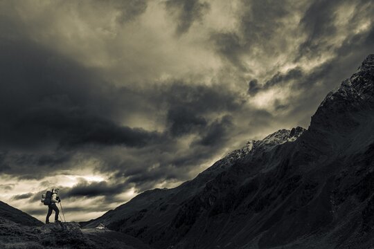 Mountaineer with backpack on stone in the background Potsdamer H&uuml;tte, Sellrain, Innsbruck, Tyrol, Austria