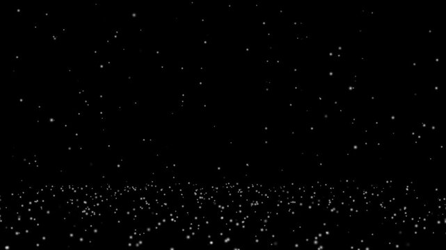 Natural randomly falling snow dust particles on black background. Winter glitter shine effect. Isolated Christmas blurred snowfall loop overlay. Beautiful snowing in cold winter holiday footage.