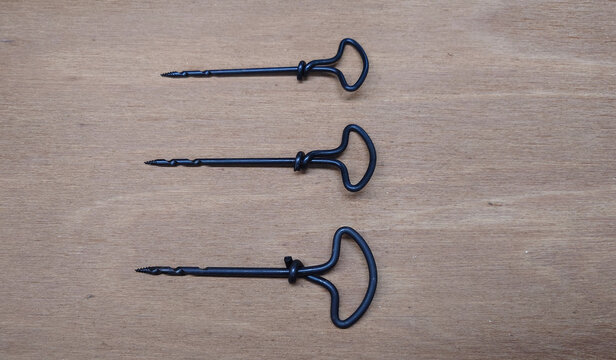 three different size twist gimlets for boring pilot holes in wood by hand