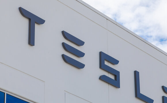 Corporate TESLA building exterior showing bold stylized lettering and modern facade elements at a commercial technology facility