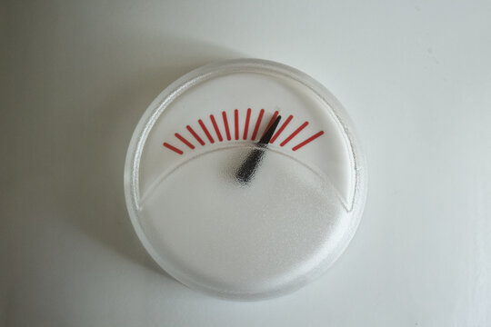 Boiler temperature gauge arrow showing maximum heat level inside water heater indicator close up