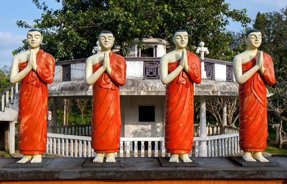 A row of Buddhist monk statues stand in front of the Image House at the Sigiriya Buddhist Temple in Sri Lanka.