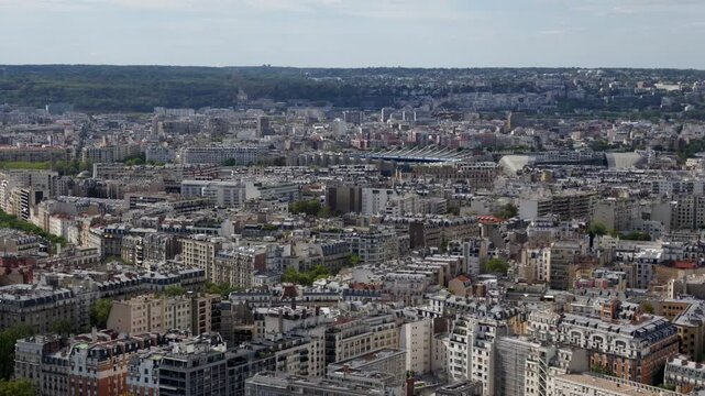 Panoramic aerial view of Paris cityscape with buildings and rooftops extending to the horizon