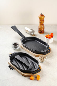 Cast Iron Sizzler Plate and Grill Pan with Wooden Base and Fresh Spices
