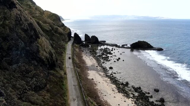 Aerial tracking of a traditional cogon tricycle on the coastal Chatapuyan Road in Ivana, Batanes