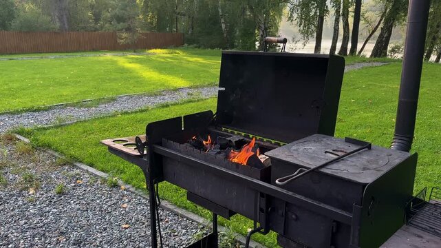 Burning Fire and Hot Charcoal in Outdoor Barbecue Grill, Open Flames in Metal BBQ Brazier for Outdoor Cooking and Backyard Grilling