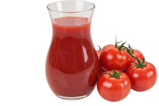 A clear glass pitcher filled with fresh red tomato juice next to a cluster of ripe tomatoes on the vine isolated on a transparent background