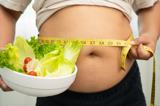 Asian woman with fat belly big size overweight and obesity with healthy food.
