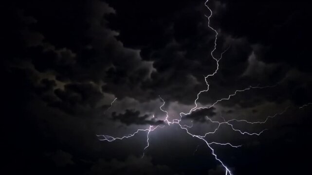 Dramatic electrical lightning storm with bright flashes in dark night sky.