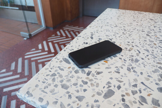 Smartphone on table in cafe during the day. lost phone concept 