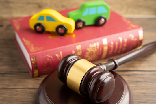 Hammer gavel judge with car vehicle accident, insurance coverage claim lawsuit court case.