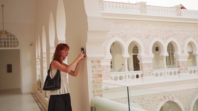 Female tourist taking pictures of sultan abdul samad building