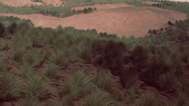 A view of an open landscape featuring patches of grass and rolling hills under a clear sky. The scene indicates a rural area with distant trees and natural features.