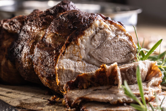 Detailed macro shot of juicy roasted pork shoulder with a perfectly browned crust. 