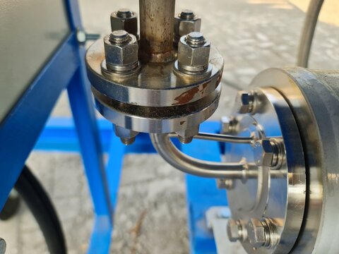 Macro Close-Up of a High-Pressure Stainless Steel Flange Connection with Bolts, Gasket, and Instrument Tubing for Industrial Engineering