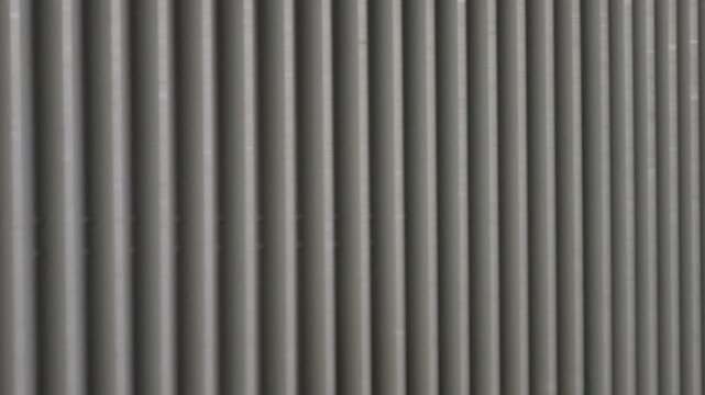 Close-up of the ribbed metal side panel of a train carriage, Cannes, France