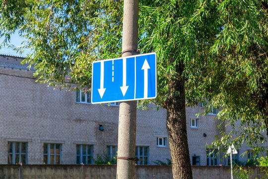 Blue traffic sign indicating lane directions