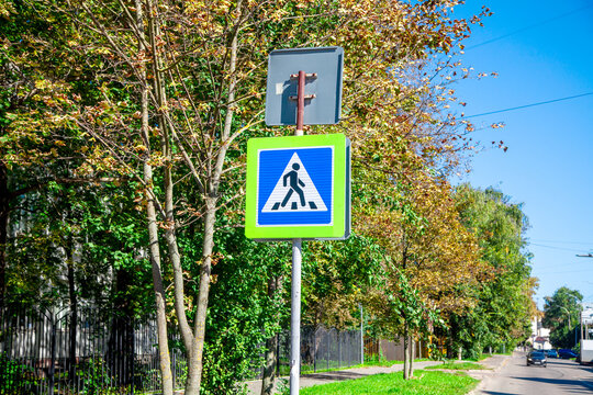 Pedestrian crossing road sign on pole