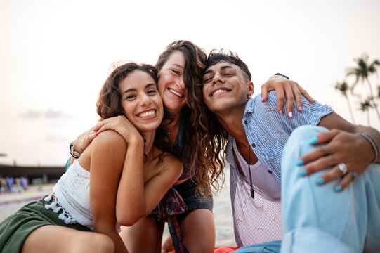 Happy college students on a summer trip, enjoying freedom and fun at the seaside resort