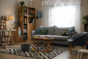 Modern domestic living room interior featuring home office desk workspace and children play area. Image suitable for real estate marketing and family housing advertising © Seventyfour
