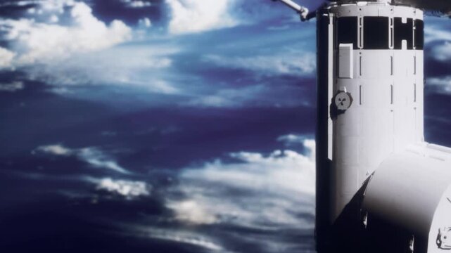 A spacecraft is seen docked at the International Space Station. The station floats in space with Earth visible in the background. Clouds surround the planet below.