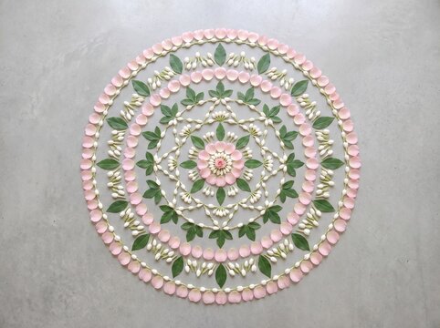 Minimalist pastel Pookalam floral design made of white jasmine and pink petals