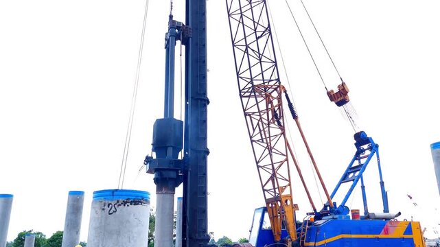 spun pile foundation process, diesel hammer drops the load onto the pile material driving into the ground at the construction site.