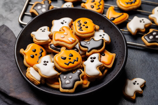 Halloween cookies on black stone background with copy space