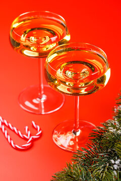 Champagne glasses and snowy fir branches