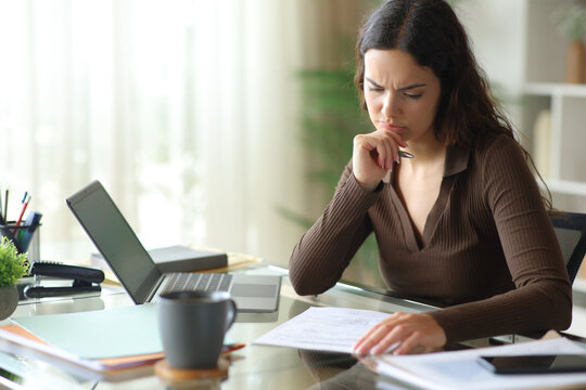 Doubtful telecommuter reading carefully a contract or form