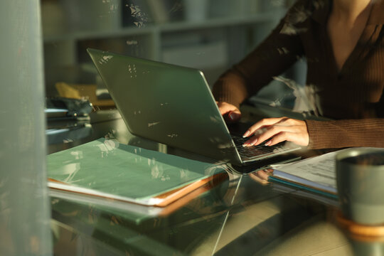 Telecommuter hands writing on laptop working at home