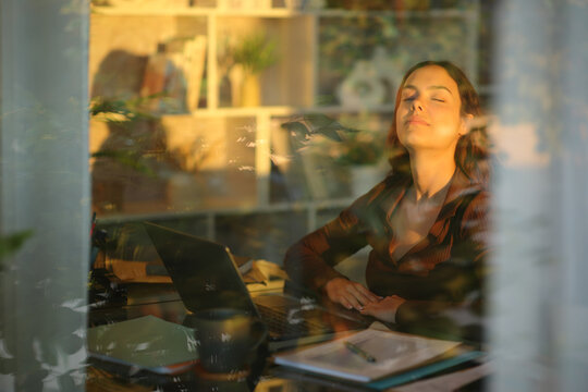 Telecommuter relaxing breathing fresh air at sunset at home