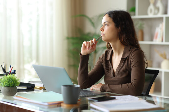 Pensive telecommuter thinking working at home