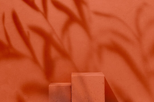 Product Presentation Scene made with Two Terracotta Cube Podiums with Dramatic Branch Shadow on Terracotta Monochrome Background