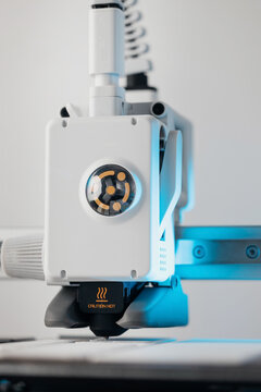 Extreme macro shot of 3D printer nozzle printing white plastic object