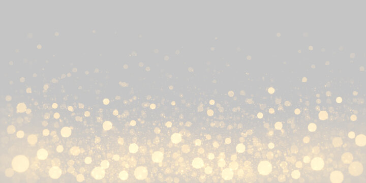 Golden light particles float on a black background. These vibrant shimmering orbs vary in size and create a sense of depth and sparkling motion in the dark space.