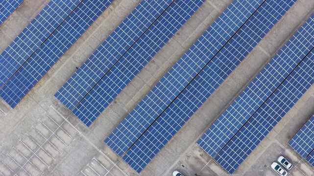 Forward overhead view across parallel rows of solar panel carports