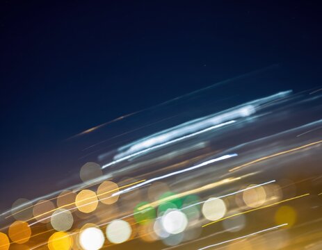 Abstract motion blur of city lights at night with bokeh effect