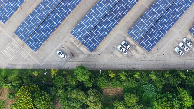 Overhead tracking view of solar carport ends and parked cars