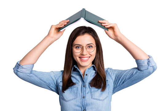 Close up photo of pretty funky lady hold open book above head wear spectacles blue cloth isolated on grey background