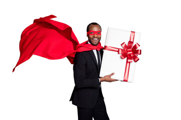 Portrait of nice attractive cheerful cheery guy wearing suit hero outfit holding in hands giftbox occasion greetings air blow wind fly isolated over grey pastel color background © deagreez