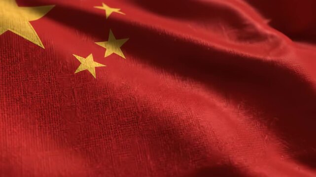 Close-up of the national flag of China waving in the wind, showcasing its vibrant red color and yellow stars, symbolizing the nation's rich history and communist ideology.