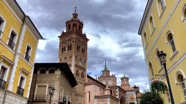 Historic Cathedral and Tower in Teruel Spain Under Stormy Sky