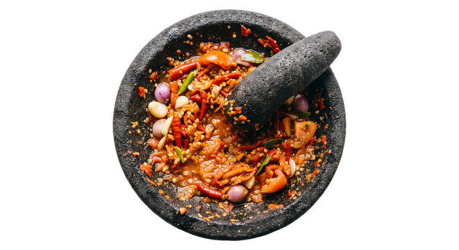 Top view flatlay of fresh homemade Indonesian sambal ulek paste with crushed red chili peppers, garlic, shallot, and tomato in traditional stone mortar cobek isolated on transparent background