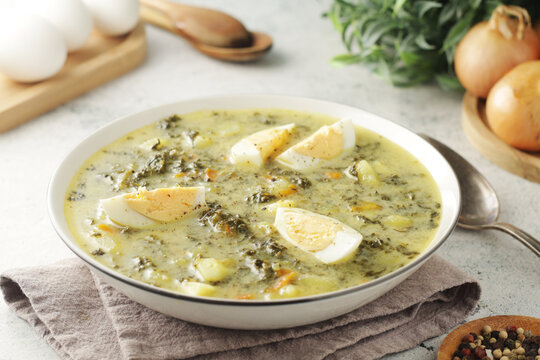 A bowl with traditional Polish sorrel soup Zupa Szczawiowa