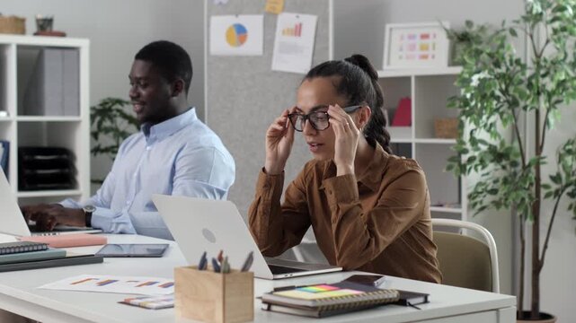 Tired businesswoman feeling exhausted from work overload in office
