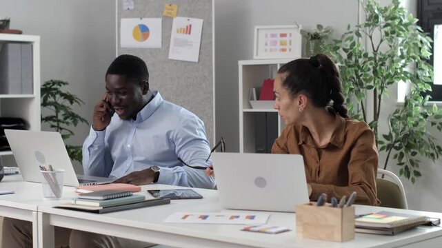 Noisy colleague talking loudly on phone annoying coworker