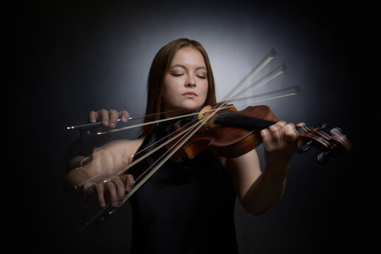 Caucasian young adult woman playing violin with stroboscopic motion effect. Visual concept representing classical music performance, suitable for concert promotion, medium shot